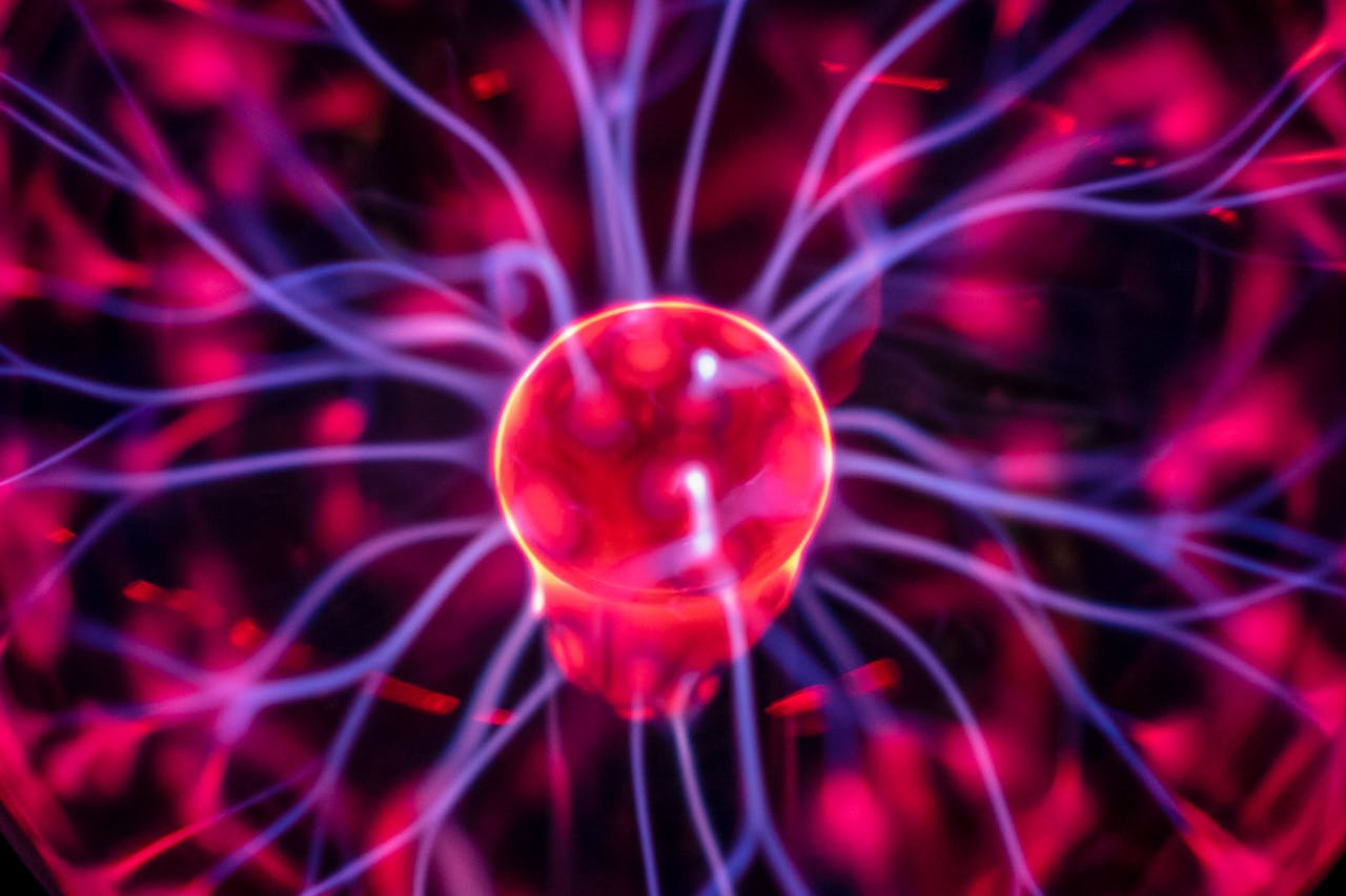 Close-up of a vibrant plasma globe with electric streams, perfect for science or energy concepts.
